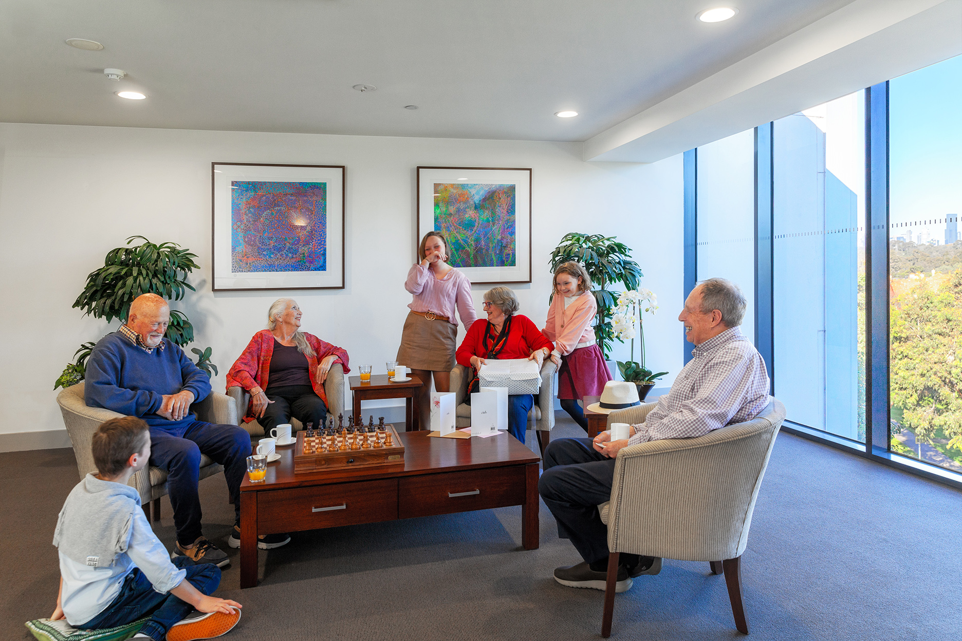 Residents gathered in the community lounge playing games at Mercy Place Parkville
