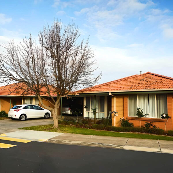 Red brick front view units at Mercy Place Rice Village during winter