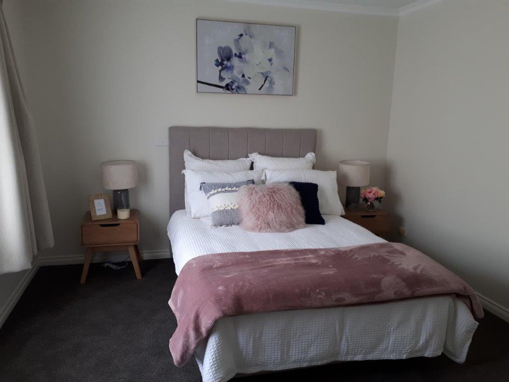 Unit master bedroom in pink and grey colour scheme at Mercy Place Rice Village retirement